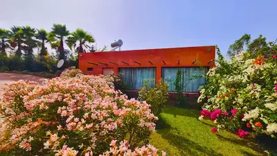 a red house with flowers in front of it at Villa Deneb - secret garden, swimming pool and starry sky in Marrakech
