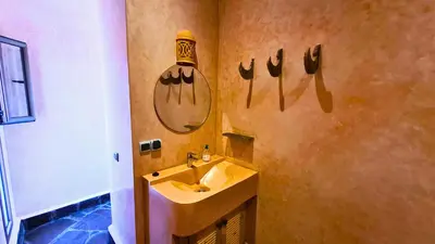 a bathroom with a sink and a mirror on the wall at Villa Deneb - secret garden, swimming pool and starry sky in Marrakech