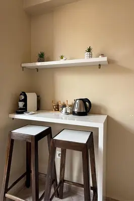 a kitchen with two stools and a counter with a microwave at Idéal Famille Neuf - Fibre Optique - 7 min Guéliz in Marrakech