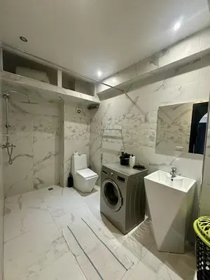 a bathroom with a washing machine and a toilet at studio équipé et centrale -Guéliz in Marrakech