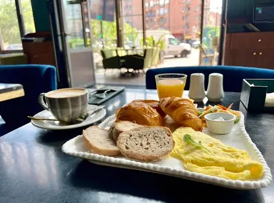 a plate of breakfast food with bread and eggs and coffee at studio équipé et centrale -Guéliz in Marrakech