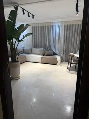 a living room with a couch and a table at Beautiful apartment in Premium Village Marrakech in Marrakech