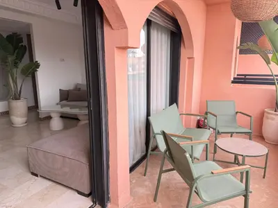 a room with chairs and a couch and a table at Beautiful apartment in Premium Village Marrakech in Marrakech