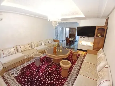 a living room with a couch and a table at AU GC Gueliz Cosy in Marrakech