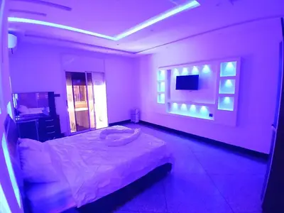 a bedroom with a bed and a flat screen tv at AU GC Gueliz Cosy in Marrakech