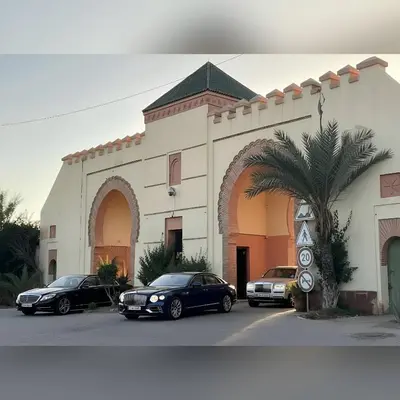 three cars parked in front of a building at La perle de la palmeraie in Marrakech