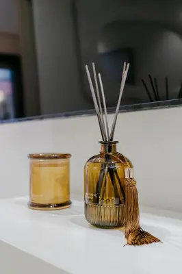 a jar with sticks in it sitting on a counter at Premium Hospitality - Hivernage Marrakech in Marrakech
