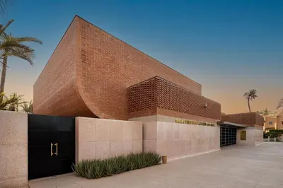 a red brick building with a black door at Premium Hospitality - Hivernage Marrakech in Marrakech