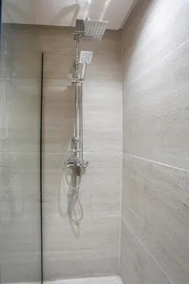 a shower with a shower head in a bathroom at Premium Hospitality - Hivernage Marrakech in Marrakech