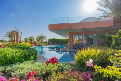 a resort with a swimming pool and flowers at Golfside Villas in Marrakech
