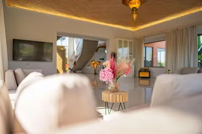 a living room with a vase of flowers on a table at Golfside Villas in Marrakech