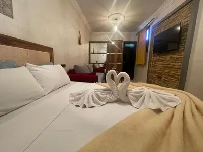 a bedroom with two swans towels on a bed at La maison de Hamza in Marrakech