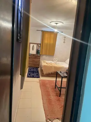 a room with a bedroom with a bed and a table at La maison de Hamza in Marrakech