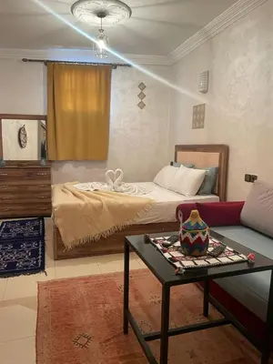 a living room with a bed and a table at La maison de Hamza in Marrakech