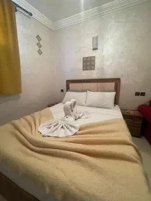 a bed with a towel on top of it at La maison de Hamza in Marrakech