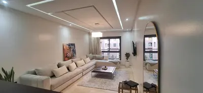 a living room with a couch and a table at Appartement Moderne Centre Gueliz Sunny Pool PS4 & Wi-Fi in Marrakech