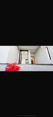 a red flower sitting on the floor of a hallway at Villa Alya in Marrakech