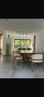 a dining room with a table and chairs in a room at Villa Alya in Marrakech