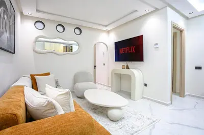 a living room with a couch and a table at Nova Collection - Hivernage Marrakech in Marrakech