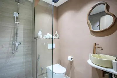 a bathroom with a shower and a toilet and a sink at Nova Collection - Hivernage Marrakech in Marrakech