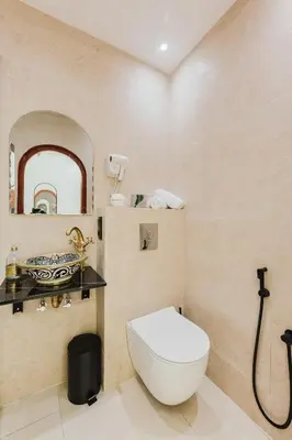 a bathroom with a toilet and a sink at Maison Joudia in Marrakech