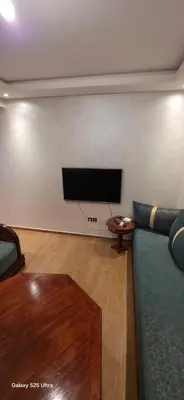 a living room with a couch and a flat screen tv at Nizar 1 in Marrakech