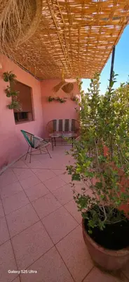 a patio with a table and chairs and plants at Nizar 1 in Marrakech