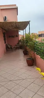 a patio with potted plants on a building at Nizar 1 in Marrakech
