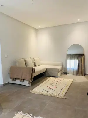 a living room with a couch and a rug at 1 bedroom apartment Miramas 2, gueliz in Marrakech