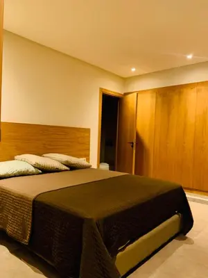 a bedroom with a large bed with a wooden headboard at 1 bedroom apartment Miramas 2, gueliz in Marrakech