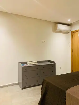a bedroom with a bed and a dresser in it at 1 bedroom apartment Miramas 2, gueliz in Marrakech