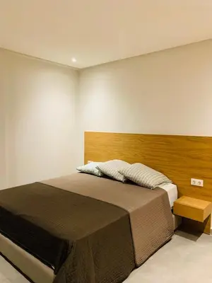 a bedroom with a large bed with a wooden headboard at 1 bedroom apartment Miramas 2, gueliz in Marrakech