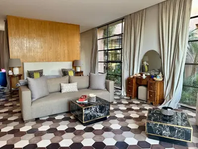 a living room with a couch and a table at Villa Serenity Marrakech in Châba