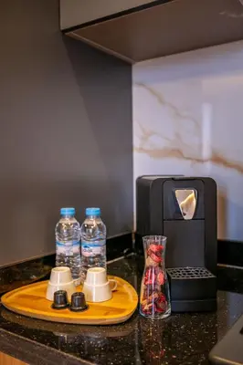 a tray with bottles of water and a toaster at Ultra Central Gueliz 1 bedroom in Marrakech