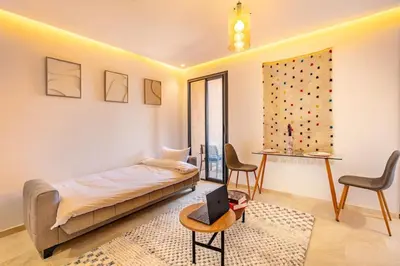 a bedroom with a bed and a laptop on a table at Ultra Central Gueliz 1 bedroom in Marrakech