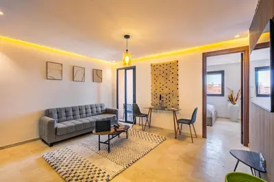 a living room with a couch and a table at Ultra Central Gueliz 1 bedroom in Marrakech
