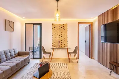 a living room with a couch and a table at Ultra Central Gueliz 1 bedroom in Marrakech