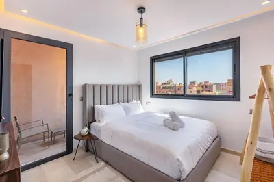 a bedroom with a large bed with a window at Ultra Central Gueliz 1 bedroom in Marrakech
