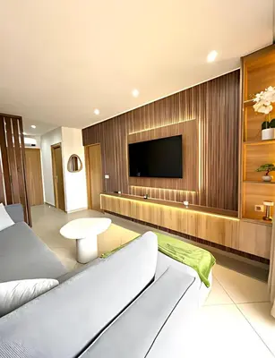 a hotel room with a tv and a couch at Central Gueliz Apartment Walk to Train Station in Marrakech