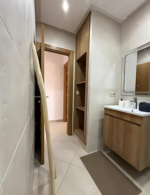 a bathroom with a sink and a counter and a door at Central Gueliz Apartment Walk to Train Station in Marrakech