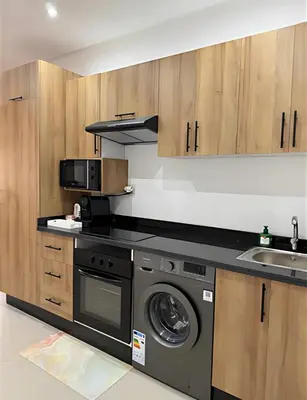a kitchen with a washing machine and a sink at Central Gueliz Apartment Walk to Train Station in Marrakech