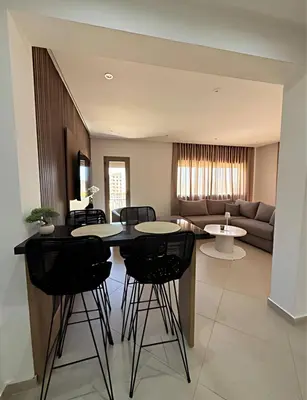 a living room with a table and chairs and a couch at Central Gueliz Apartment Walk to Train Station in Marrakech