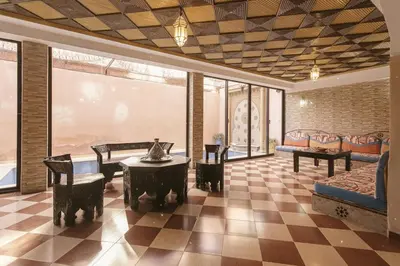 a living room with a couch and a table and chairs at Riad Safran - Private Cook & Indoor Pool Gem in Marrakech