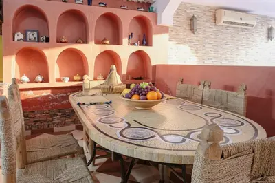a dining room with a table with a bowl of fruit at Riad Safran - Private Cook & Indoor Pool Gem in Marrakech