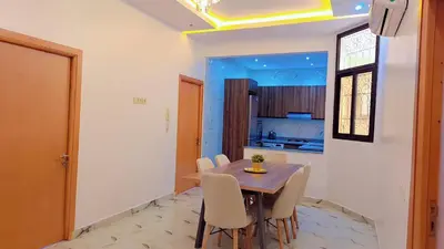 a kitchen and dining room with a table and chairs at Appartement Aéroport Suite Marrakech-M9 in Marrakech