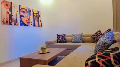 a living room with a couch and a table at Appartement Aéroport Palm Marrakech-M9 in Marrakech