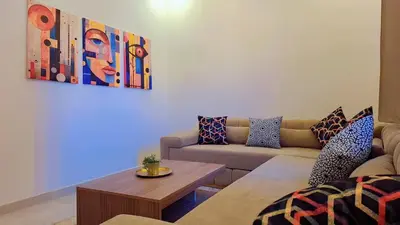 a living room with a couch and a table at Appartement Aéroport Palm Marrakech-M9 in Marrakech