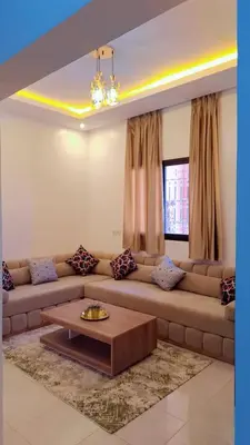 a living room with a couch and a coffee table at Appartement Aéroport Center Marrakech in Marrakech