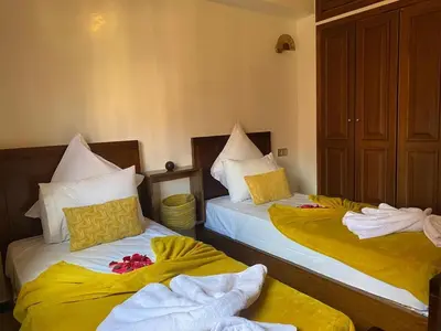 two beds with towels on them in a room at Elegance and comfort in the heart of Marrakech in Marrakech