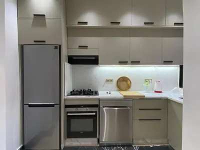a kitchen with white cabinets and stainless steel appliances at Elegance and comfort in the heart of Marrakech in Marrakech